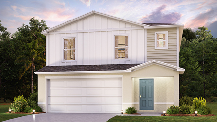 A white house with a green lawn.