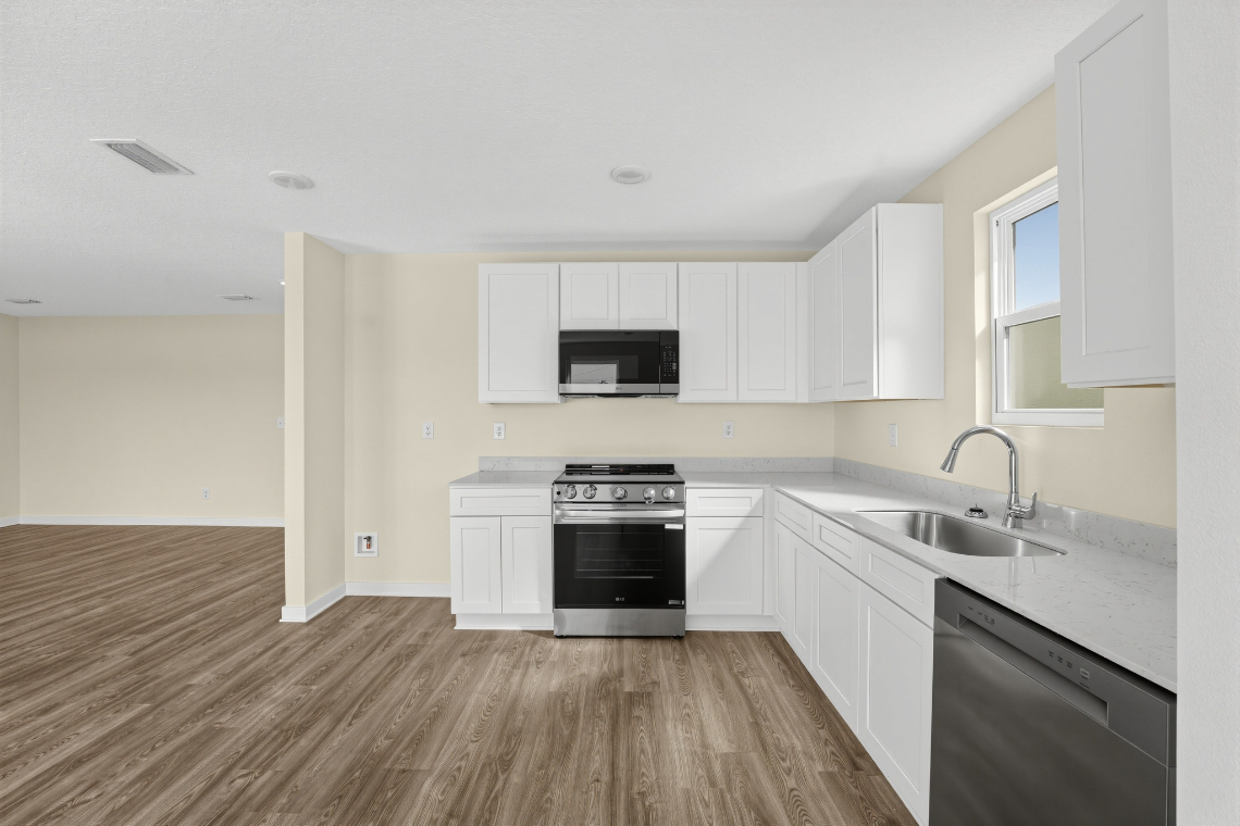 A kitchen with white cabinets.