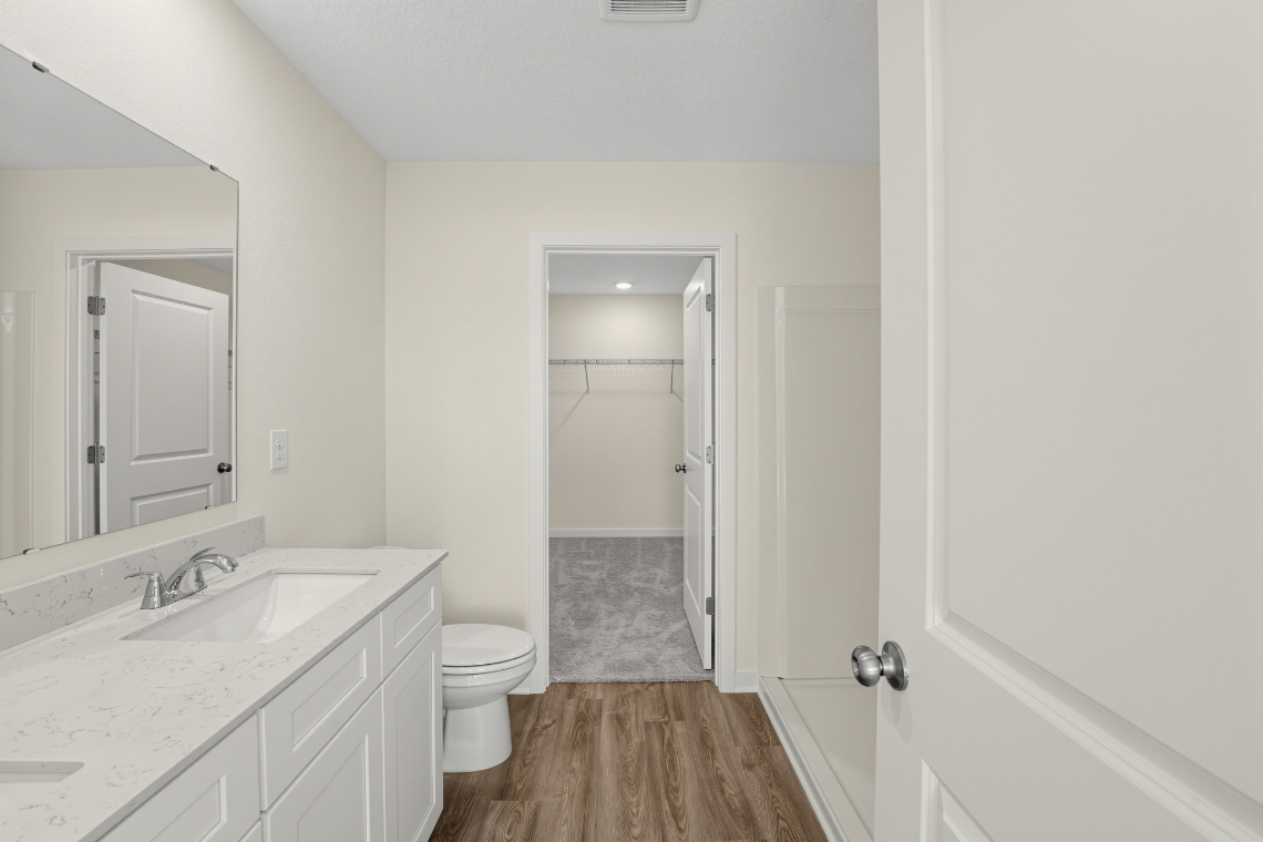 A bathroom with a sink toilet and shower.