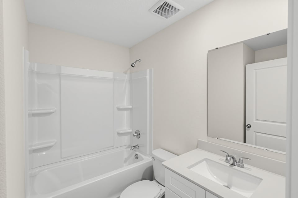A bathroom with a tub sink and toilet.
