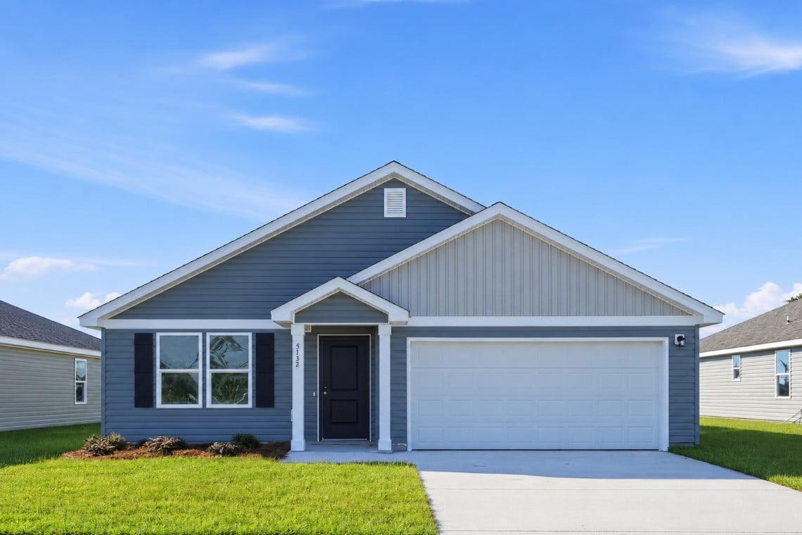 A white house with a garage.