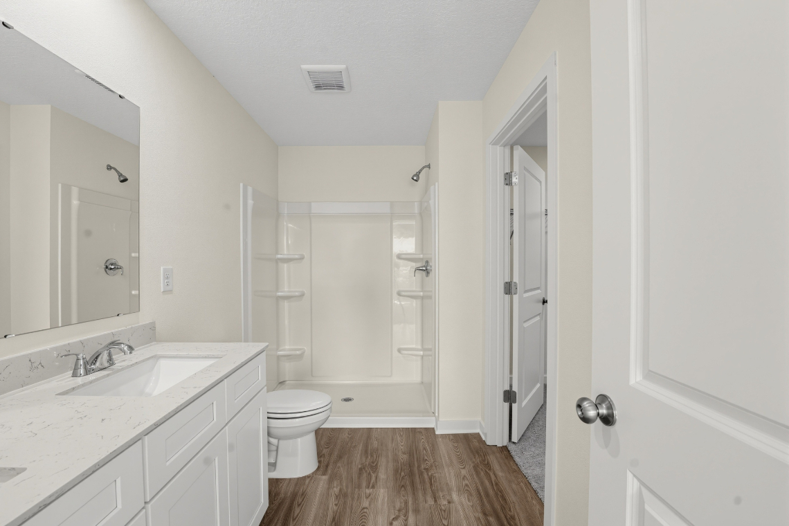 A bathroom with a toilet and sink.