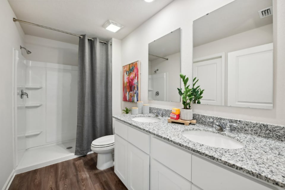 A bathroom with a tub sink and toilet.