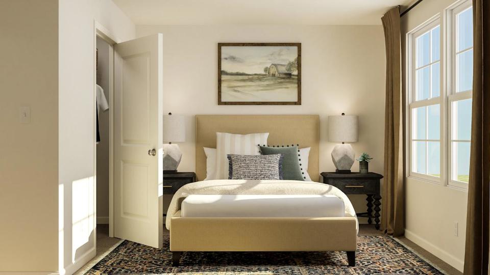 A bedroom with a bed and a table.