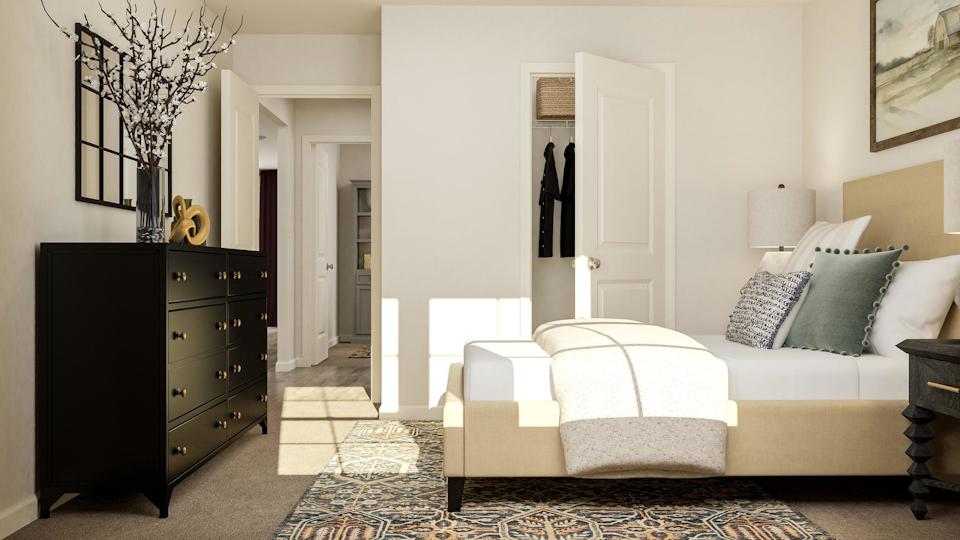 A room with a bed and dresser.