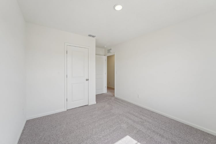 A hallway with white doors.