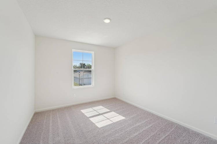 A room with a window and a tile floor.