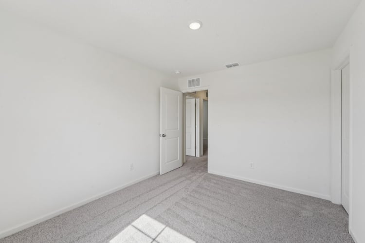 A hallway with white walls.