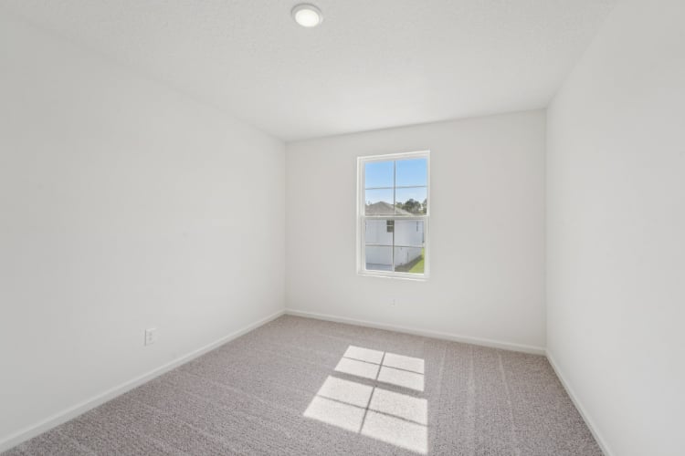 A room with a window and a tile floor.