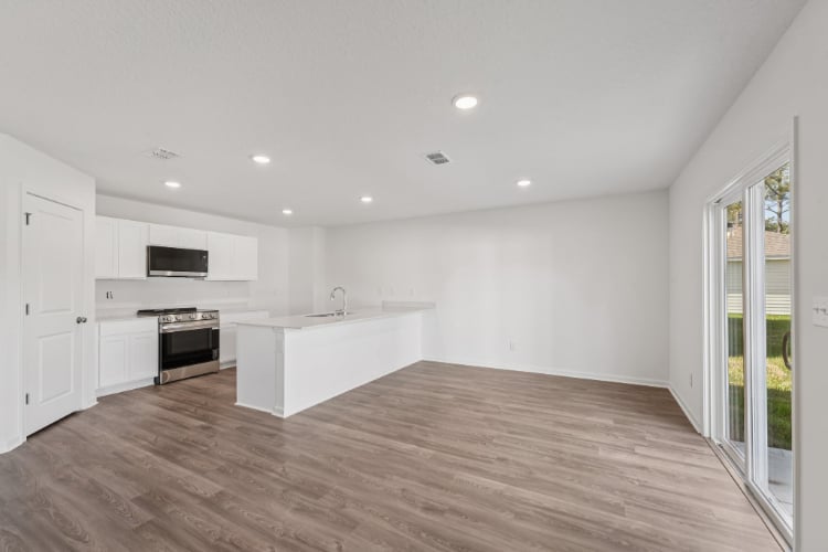 A kitchen with white cabinets.