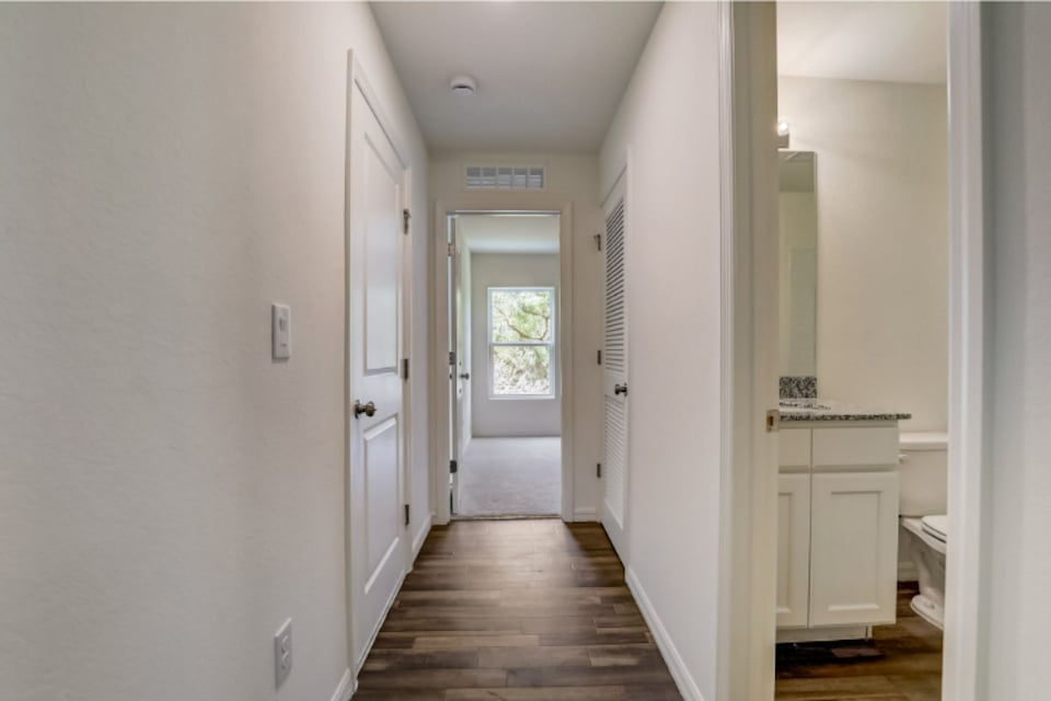 A hallway with white doors.