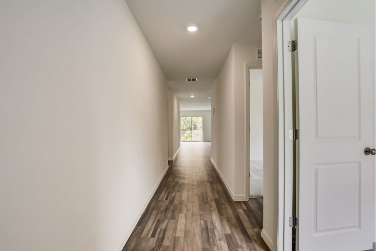 A hallway with white doors.
