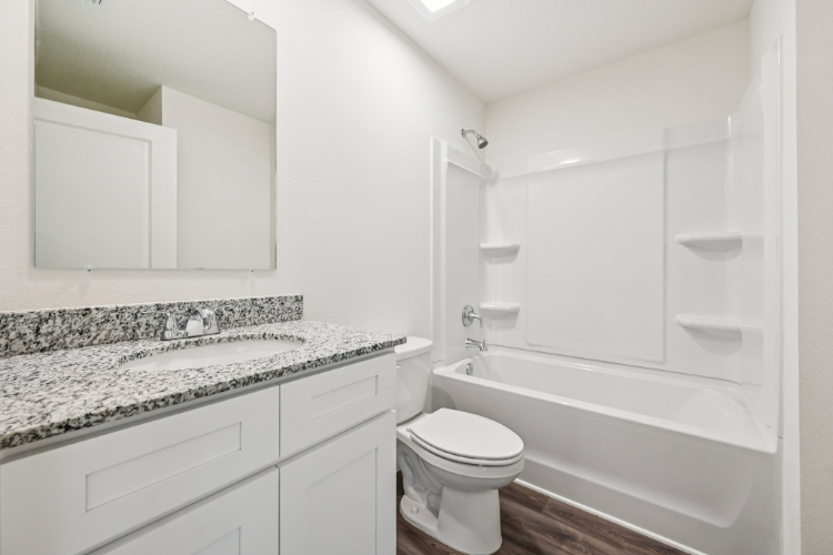 A bathroom with a marble countertop.