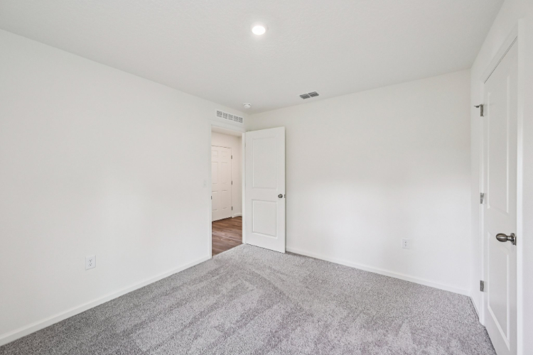 A hallway with white doors.