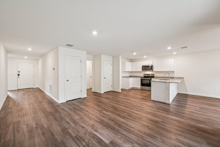 A large kitchen with white cabinets.