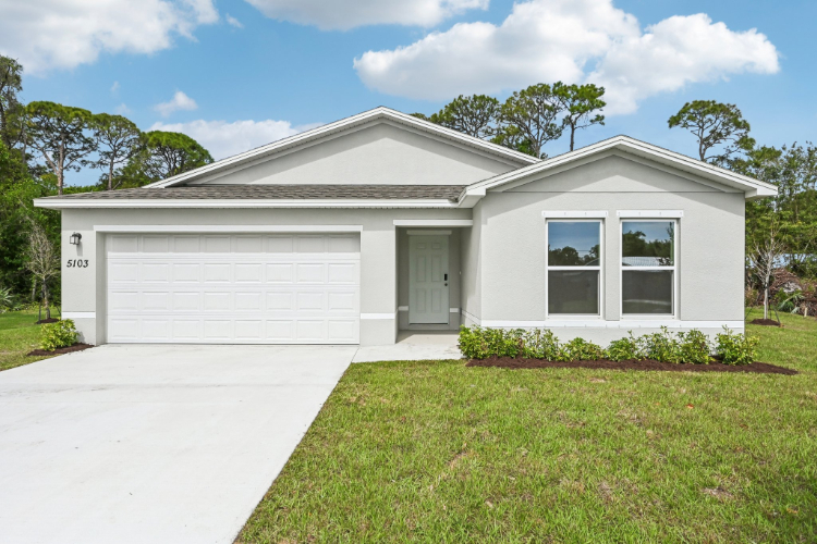 A white house with a garage.