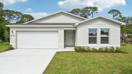 A white house with a garage.
