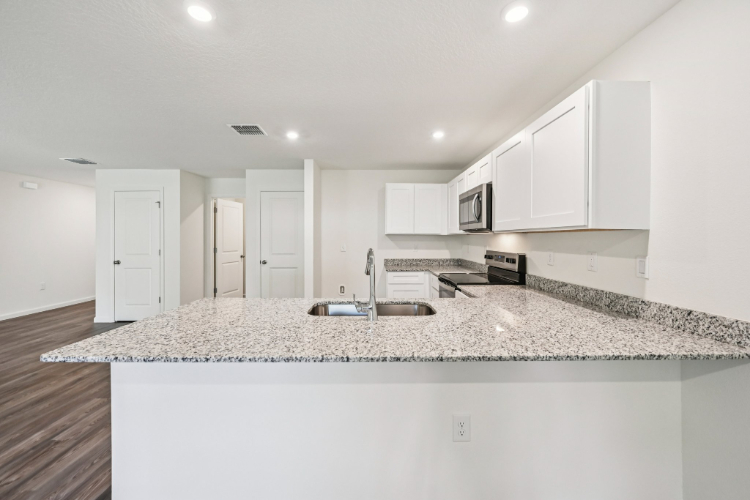 A kitchen with marble counters.