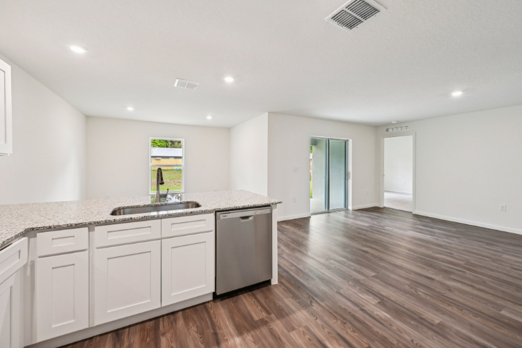 A large kitchen with white cabinets.