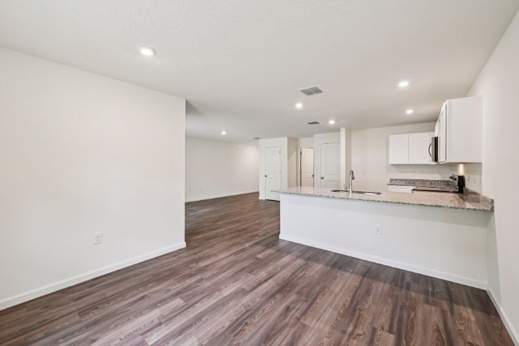 A kitchen with white cabinets.