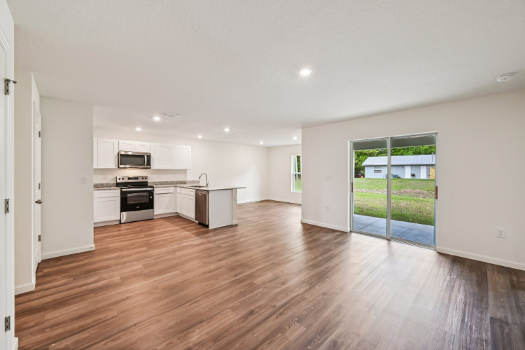 A large kitchen with a wood floor.