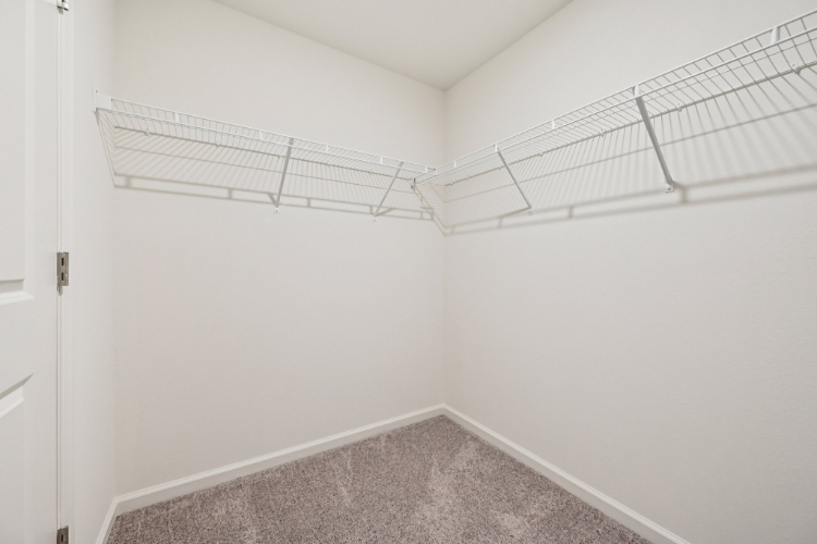 A white room with a metal railing.