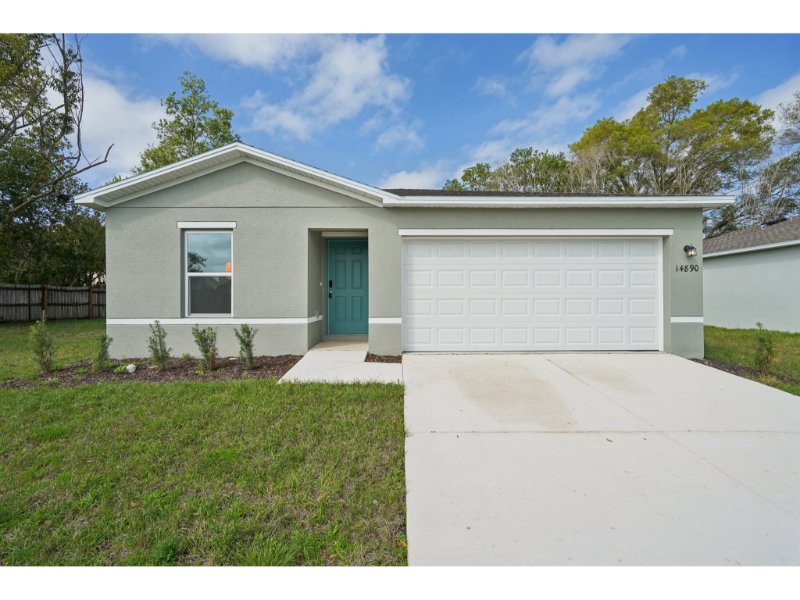 A white house with a garage.
