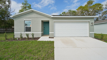 A white house with a garage.