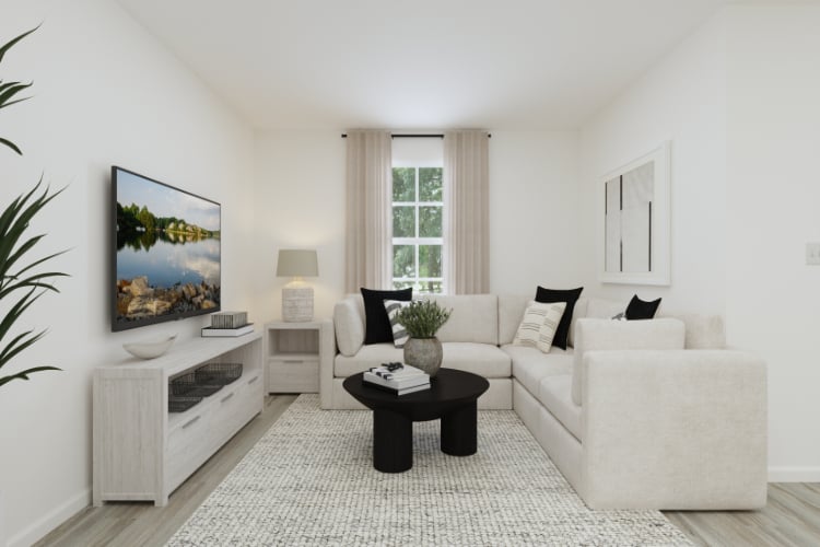 A living room with a white couch and a coffee table.
