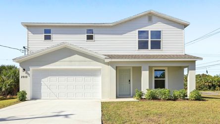A white house with a garage.