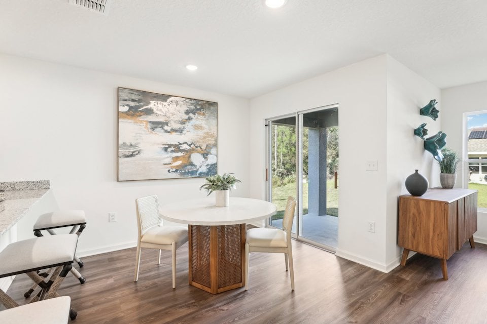 A room with a table and chairs.