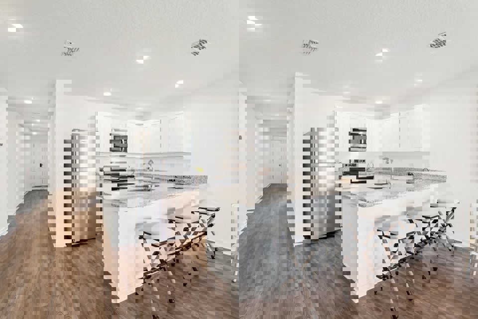 A kitchen with white cabinets.