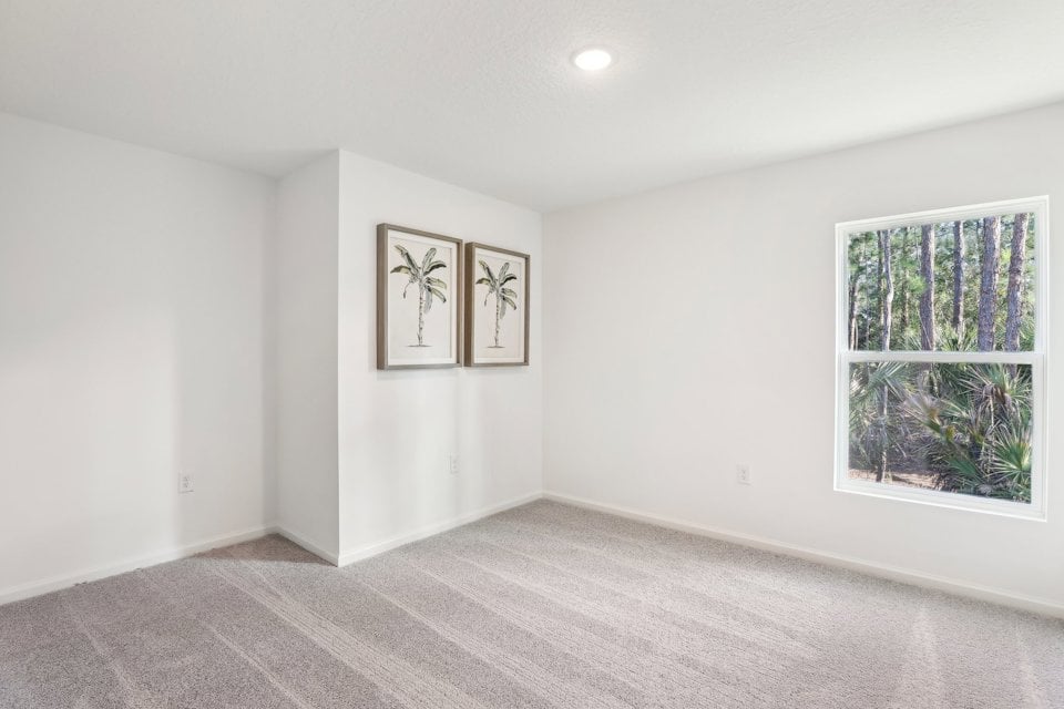 A room with a few paintings on the wall.