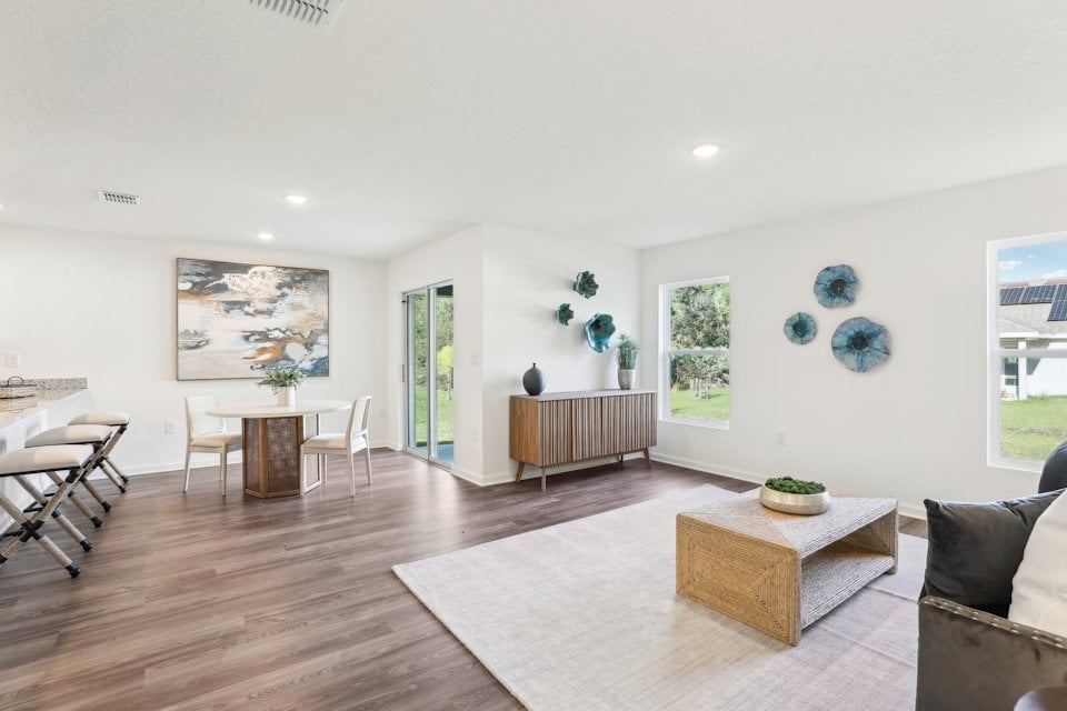 A large living room with a wood floor and a wood floor.