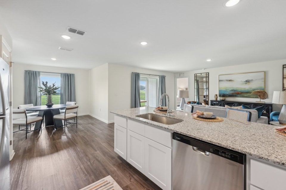 A kitchen with a marble island.