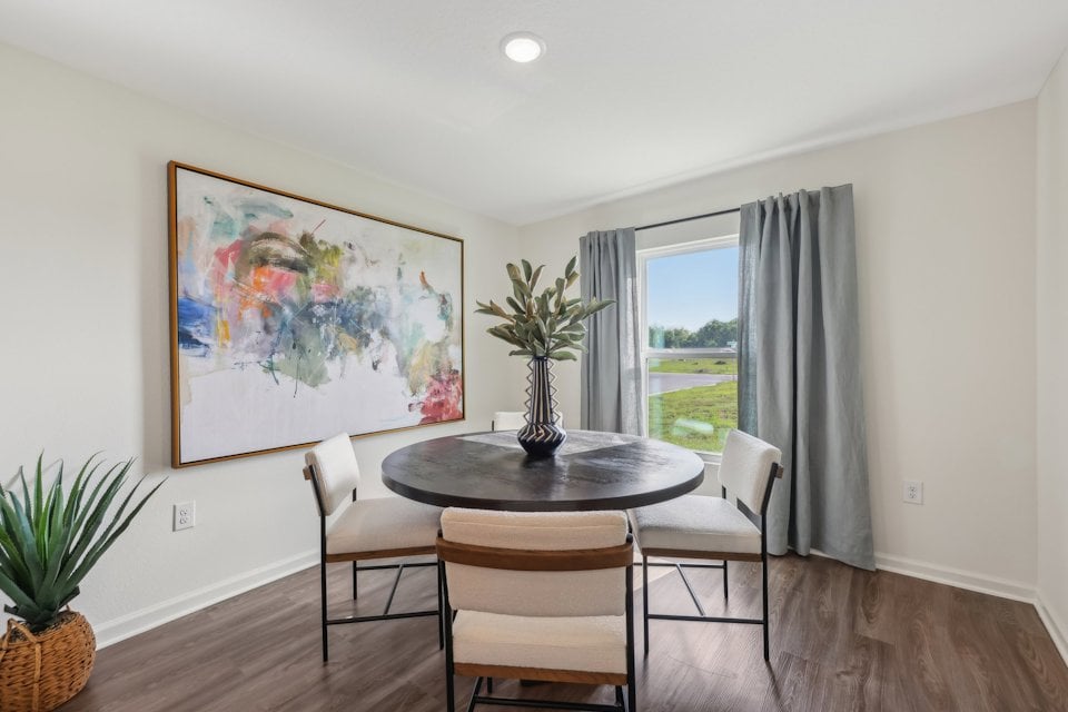 A dining room table with chairs.