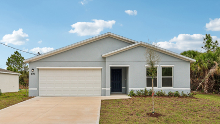A white house with a garage.