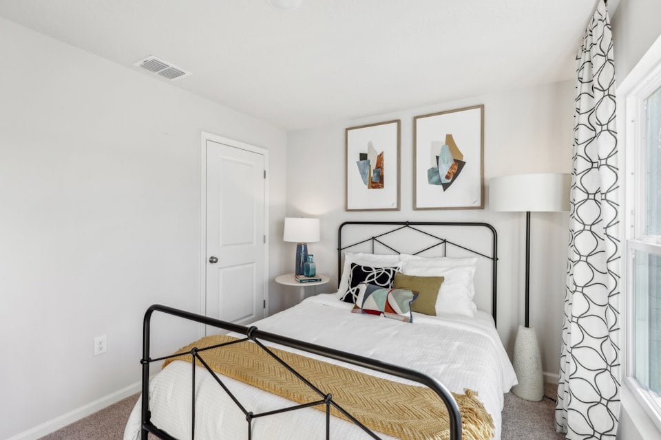 A bed with a black frame.