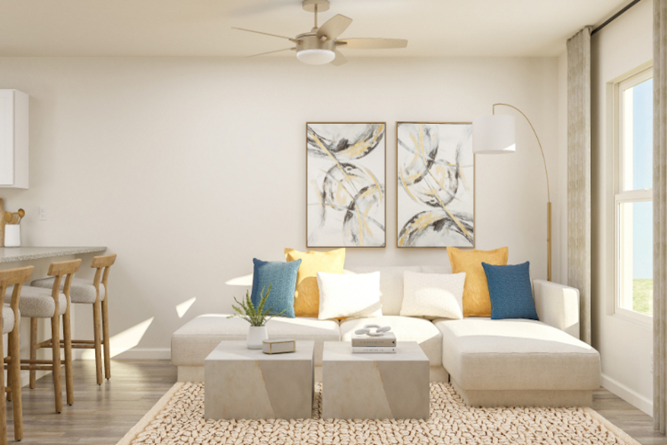 A living room with a white couch and a table.