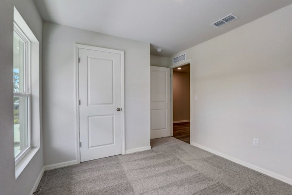 A hallway with white doors.