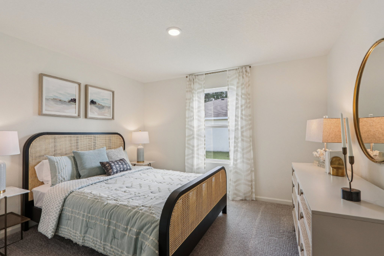 A bedroom with a bed and lamps.