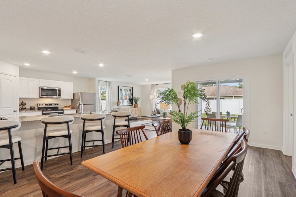 A large kitchen with a dining table.