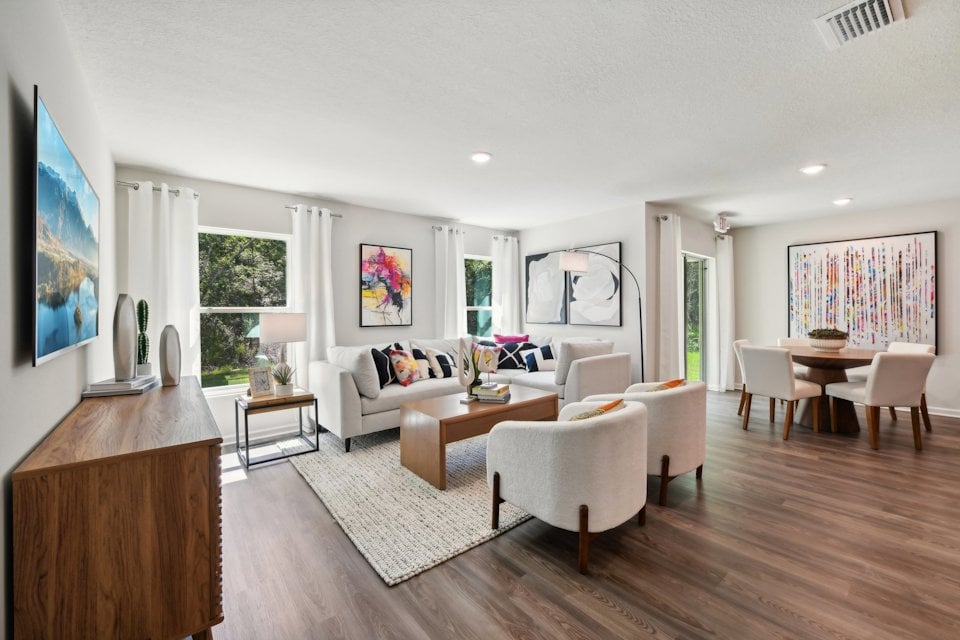 A living room with a large rug.