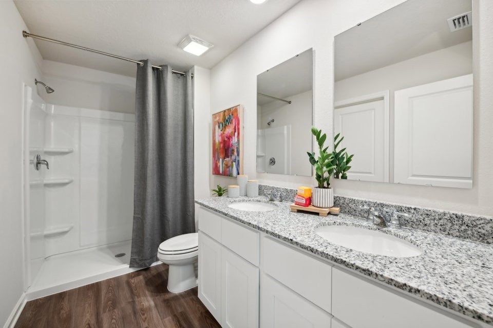 A bathroom with a tub sink and toilet.