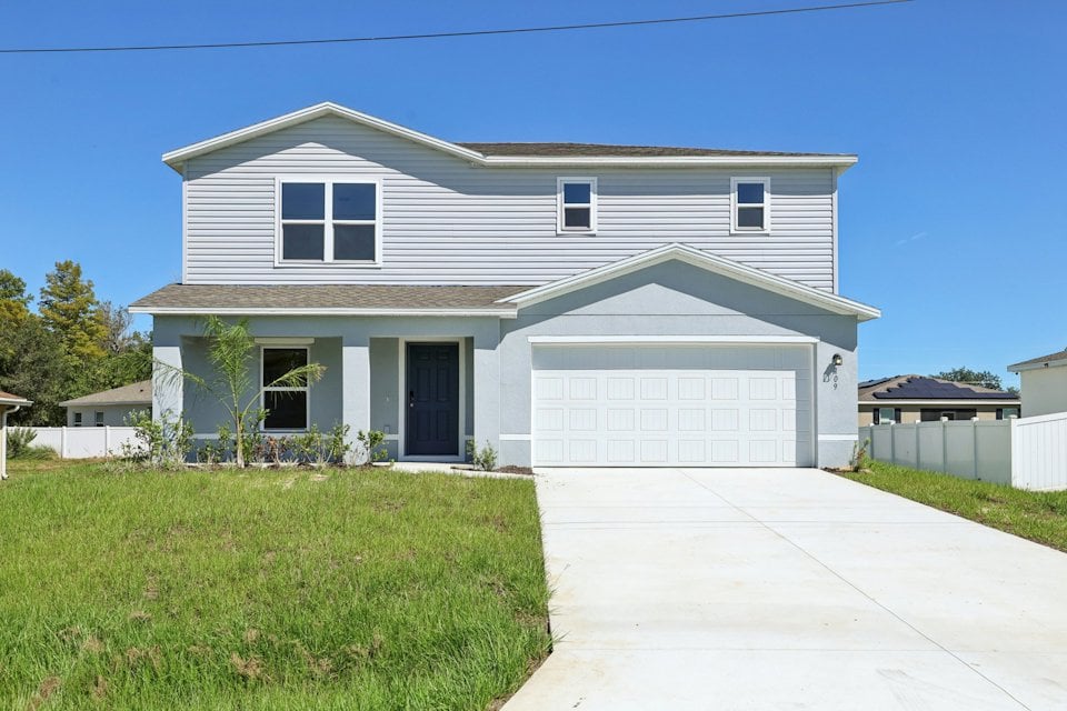 A white house with a driveway.