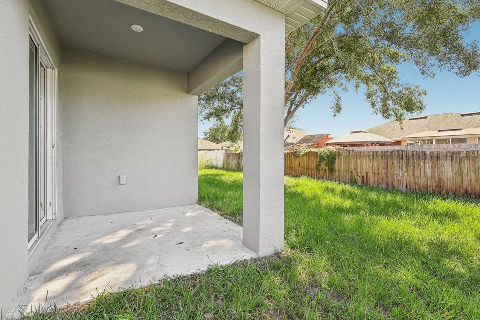 A house with a fence and grass.