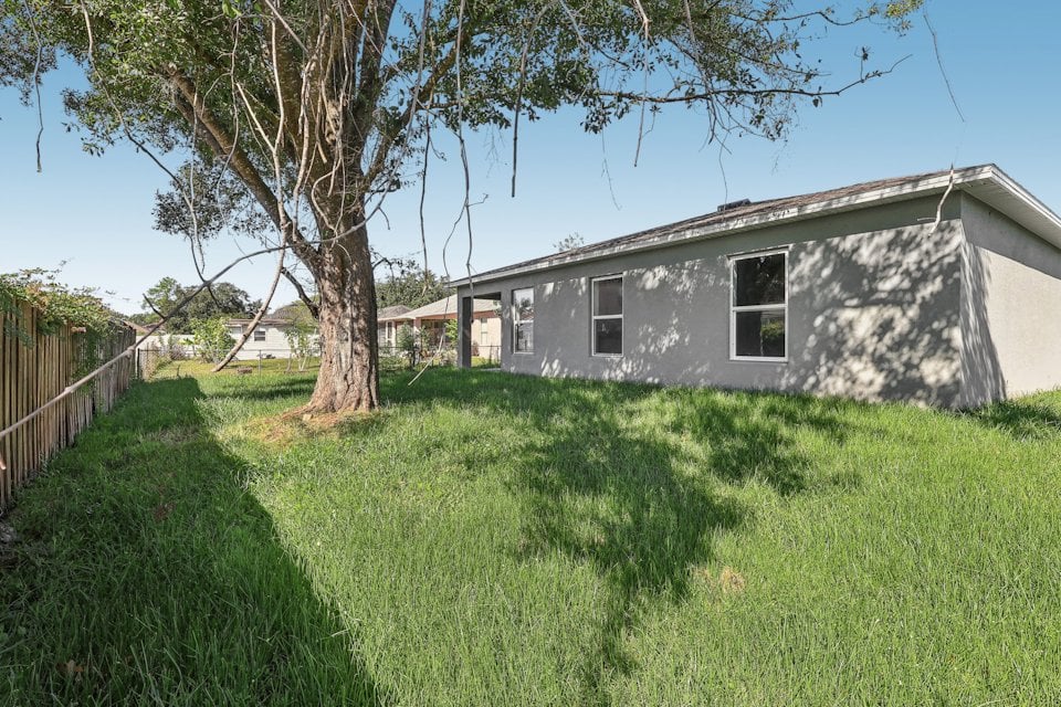 A house with a fence and trees.