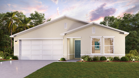 A white house with a green lawn.