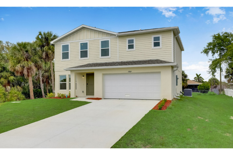 A house with a garage and trees.