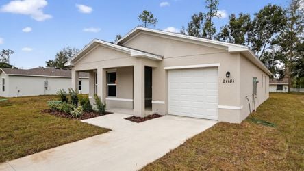 A white house with a driveway.